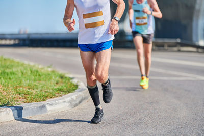 Running man. athletic man jogging in sportswear on city road. street marathon, sprinting outdoor