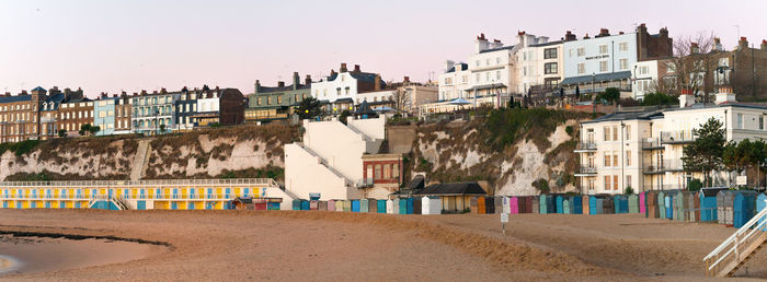 Panoramic view of beach against buildings in city