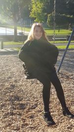 Portrait of smiling young woman in park