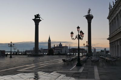 People walking on street against sky