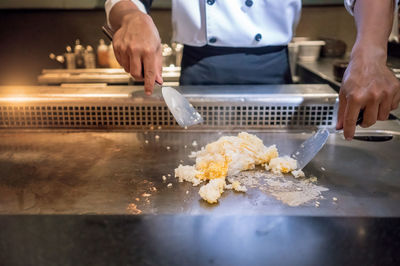 Close-up of chef preparing food in commercial kitchen