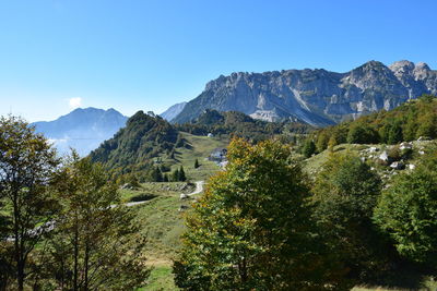 Scenic view of mountains against clear blue sky