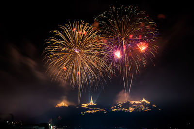 Low angle view of firework display at night