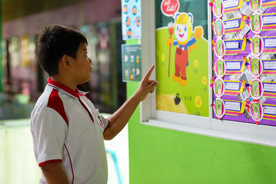 Side view of boy looking at camera