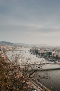 High angle view of river by city against sky