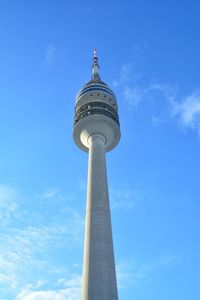 Low angle view of communications tower against cloudy sky