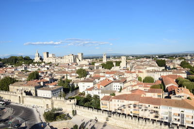 High angle view of cityscape against blue sky