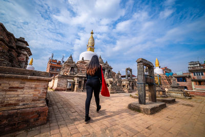 Full length of a temple against building