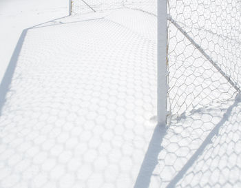 Close-up of metal fence with snow