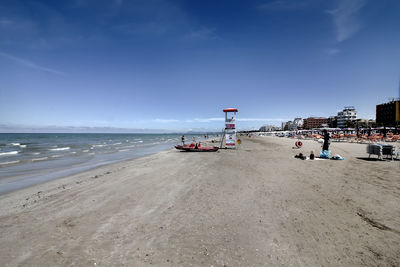 Scenic view of beach against sky in city