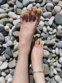 Low section of woman legs on stones