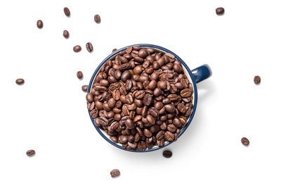 High angle view of coffee beans against white background