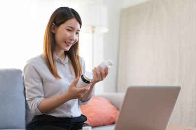 Young woman using laptop at home