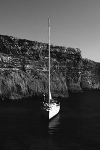 Sailboat on sea against clear sky