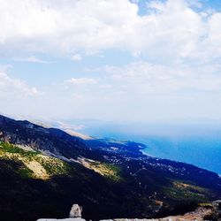 Scenic view of mountains against cloudy sky