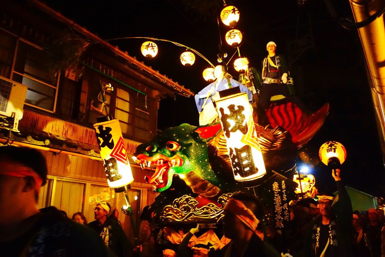 night, representation, illuminated, animal representation, group of people, celebration, art and craft, real people, built structure, festival, chinese dragon, architecture, lighting equipment, outdoors, large group of people, creativity, holiday, chinese new year