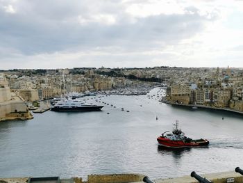 Scenic view of sea by city against sky