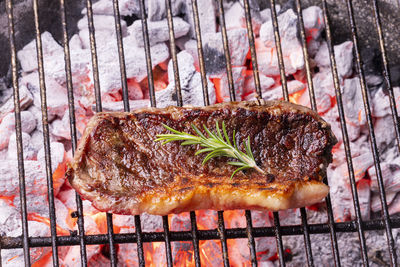 High angle view of meat on barbecue grill