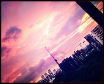 Low angle view of building against sky at sunset