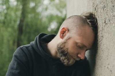 Man leaning on wall