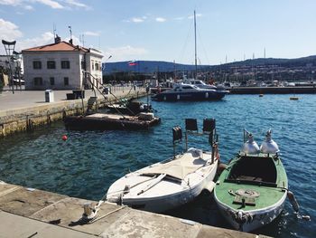 Boats moored in river