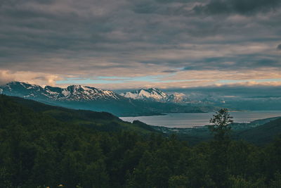 Scenic view of snowcapped mountains against sky at sunset