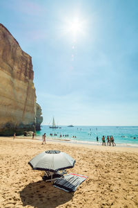 People at beach on sunny day