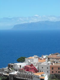 High angle view of buildings and sea against sky