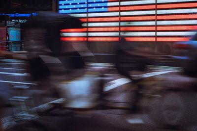 Blurred motion of people walking on street in city