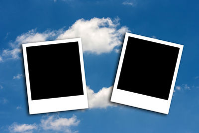 Close-up of instant print transfers against sky