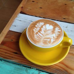 Close-up of cappuccino on wooden table