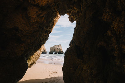 Scenic view of sea seen through cave