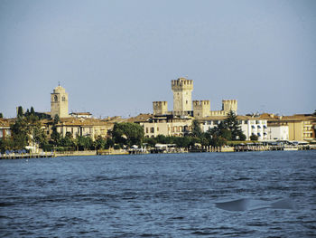 Buildings in city against clear sky