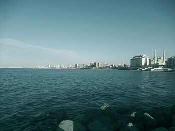 Scenic view of sea and buildings against sky