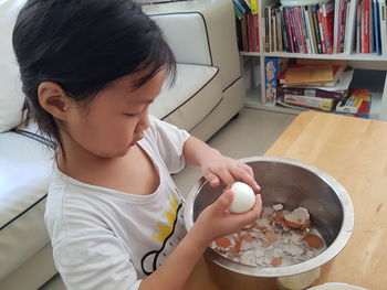 High angle view of girl holding woman at home
