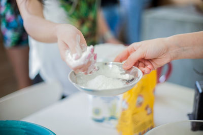 Close-up of women preparing food