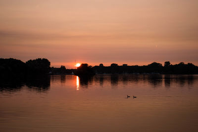 Scenic view of lake against sky during sunset