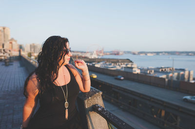 Young woman standing at building terrace 