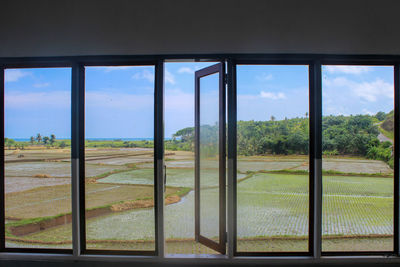 View of field seen through window