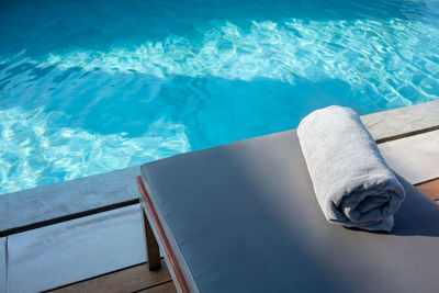 High angle view of towel on table at poolside