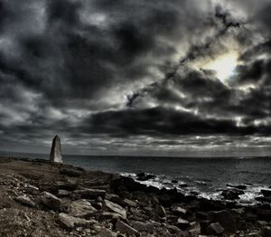 Scenic view of sea against cloudy sky