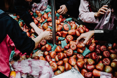 Midsection people purchasing fruits in market