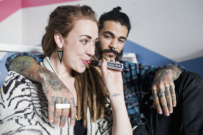 Young couple using an electronic cigarette