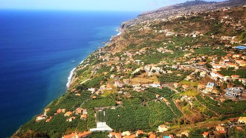 High angle view of sea and buildings against sky