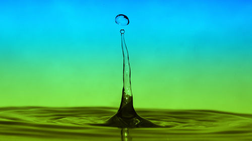 Close-up of water splashing against blue background