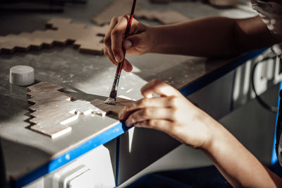 Close-up of person working on wood