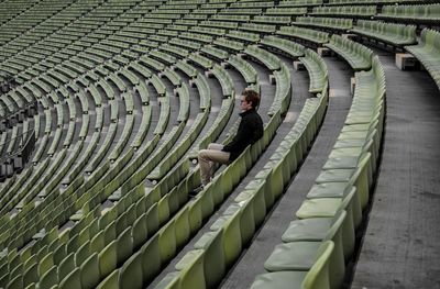 Man sitting on chair at stadium