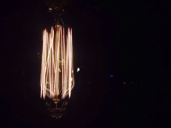 Close-up of illuminated light bulbs in darkroom