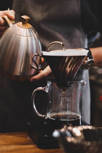 Man holding coffee cup on table