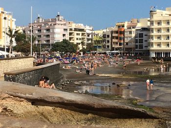 People at beach against sky